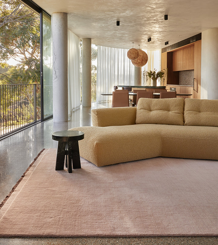 Modern open-plan living with color blocked rug